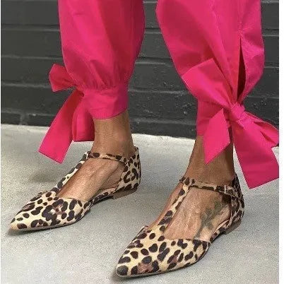 Leopard print women's pumps with a pointed toe, chunky low heel, and an ankle strap.
