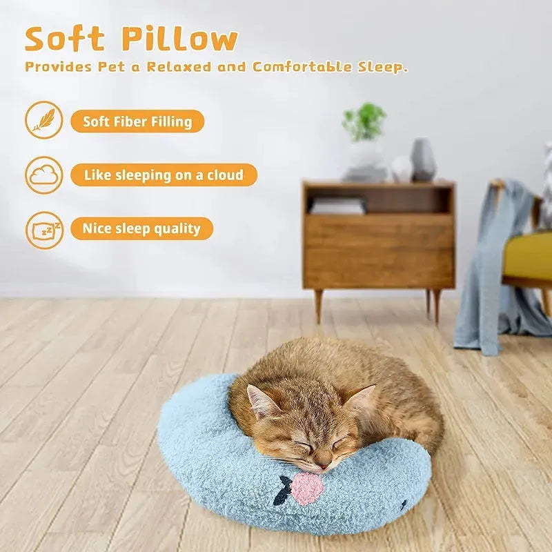 Small blue half-donut shaped pet pillow bed for cats or small dogs on a carpet.