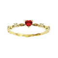 Gold or silver tone peach heart fashion ring with a zircon stone on a model finger.