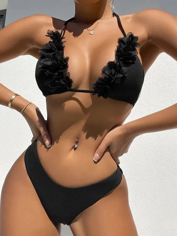Black women's two-piece bikini swimsuit with gathered design on a mannequin