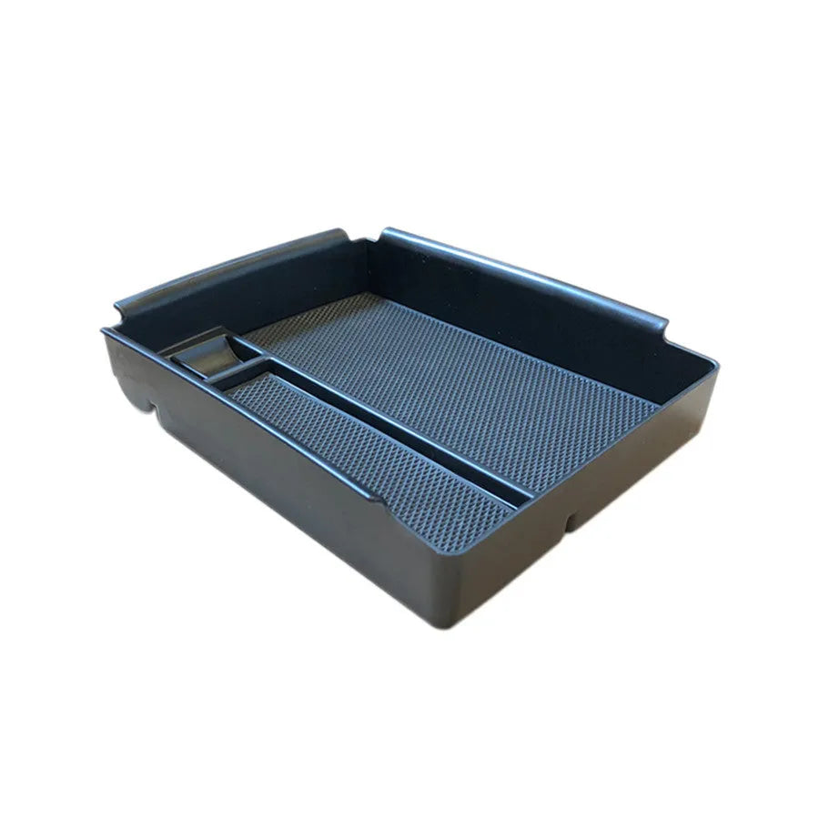 Black ABS plastic wireless charging storage box with QI fast charging support on a desk.
