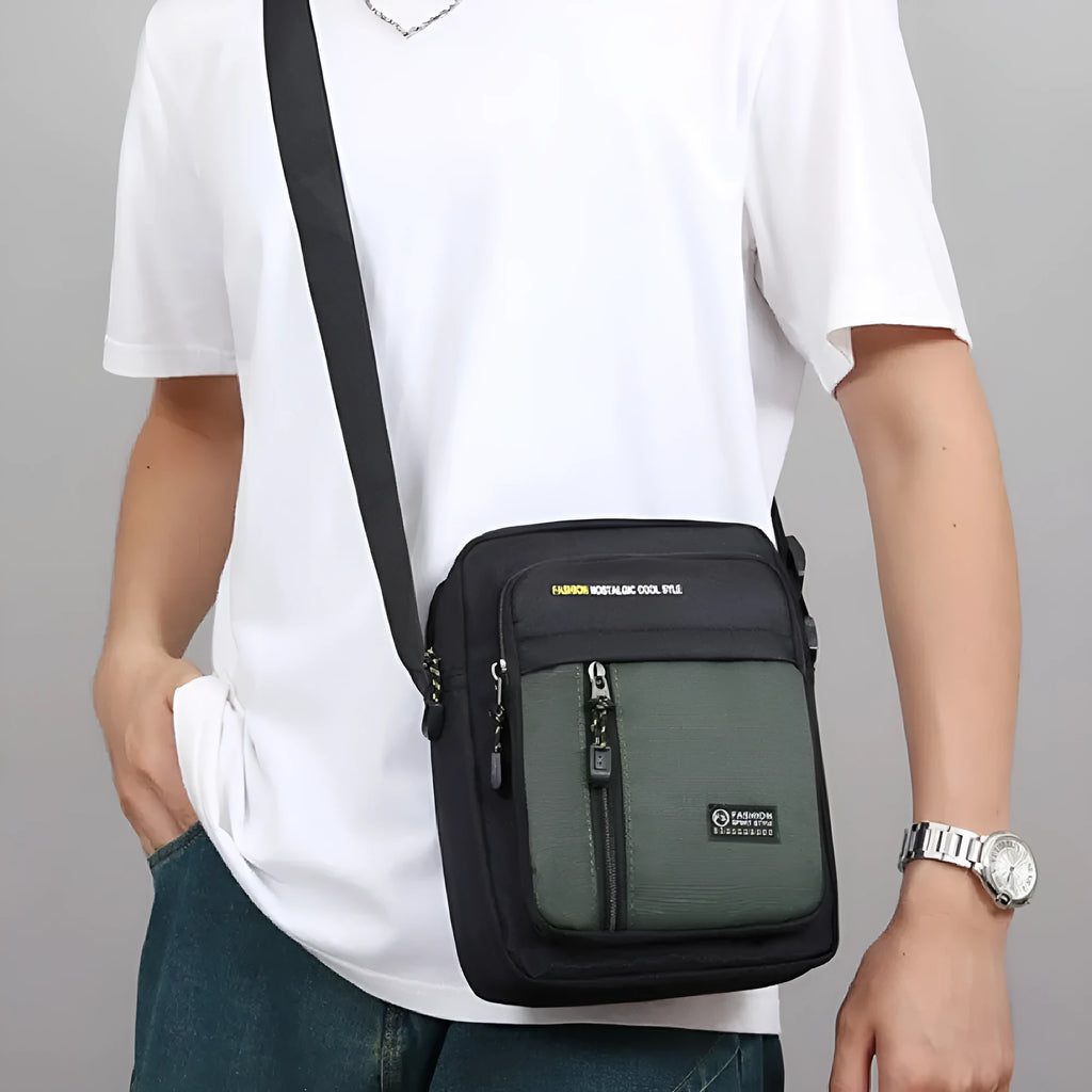 Men's casual green nylon crossbody messenger bag with visible stitching, shown from the side.