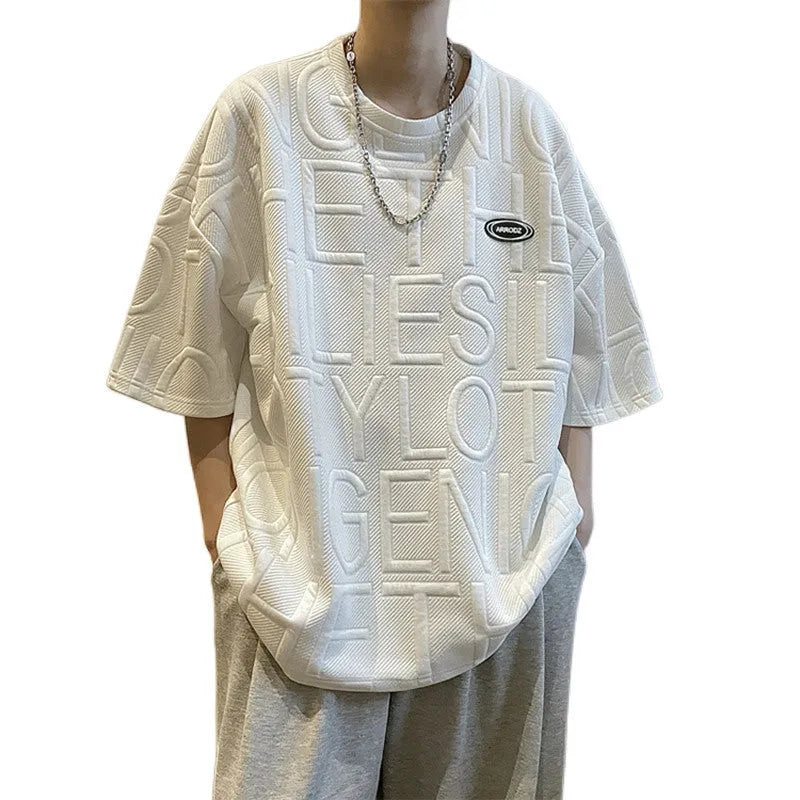 Men's gray short sleeve t-shirt with a raised three-dimensional black letter print, showing a loose retro fit.