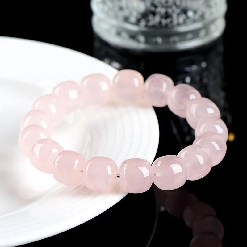 Pink crystal geometric barrel bead bracelet with 11-12mm beads on a wrist.