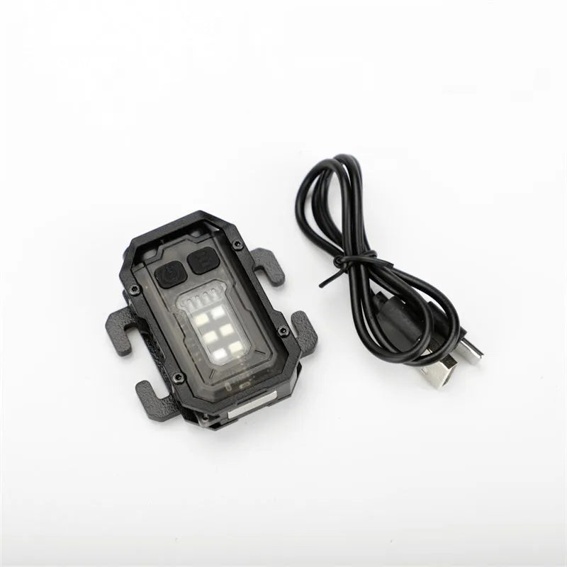 Compact USB rechargeable tactical flashlight with a black mounting clip attached to a backpack strap.