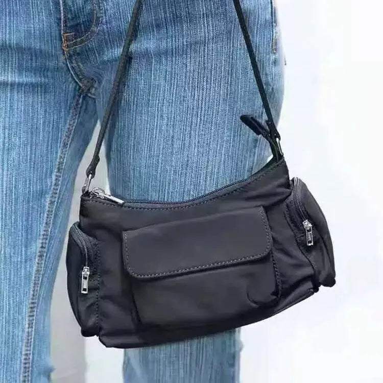 Black double pocket shoulder bag with side line detailing showing interior organisation