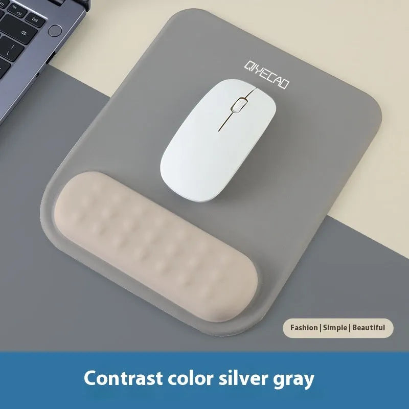 Ergonomic cloth-silicone mouse pad with raised wrist support on a desk