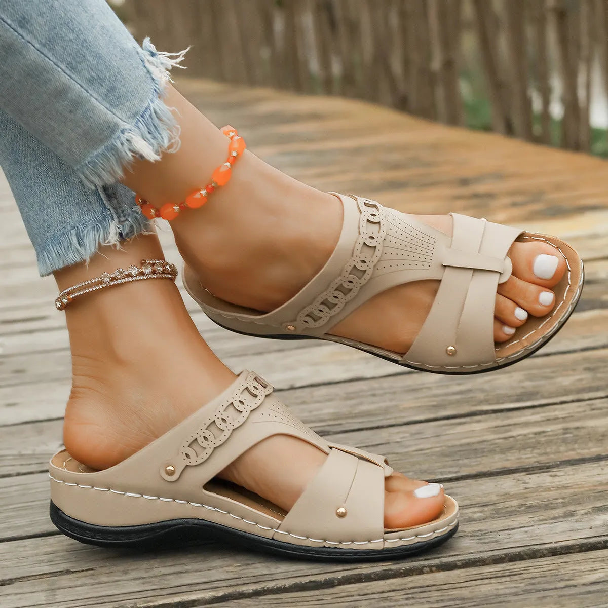 Blue Roman style slippers with a fish mouth toe holder and slope heel on a rubber sole.