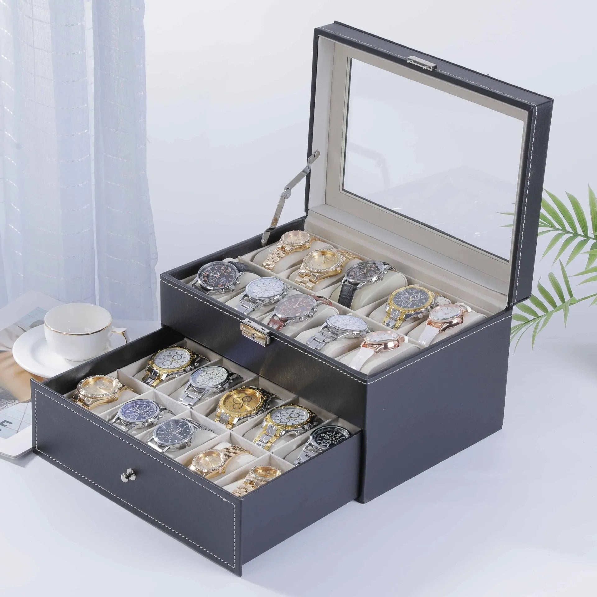 Grey leather watch storage box with transparent lid showing internal watch slots.