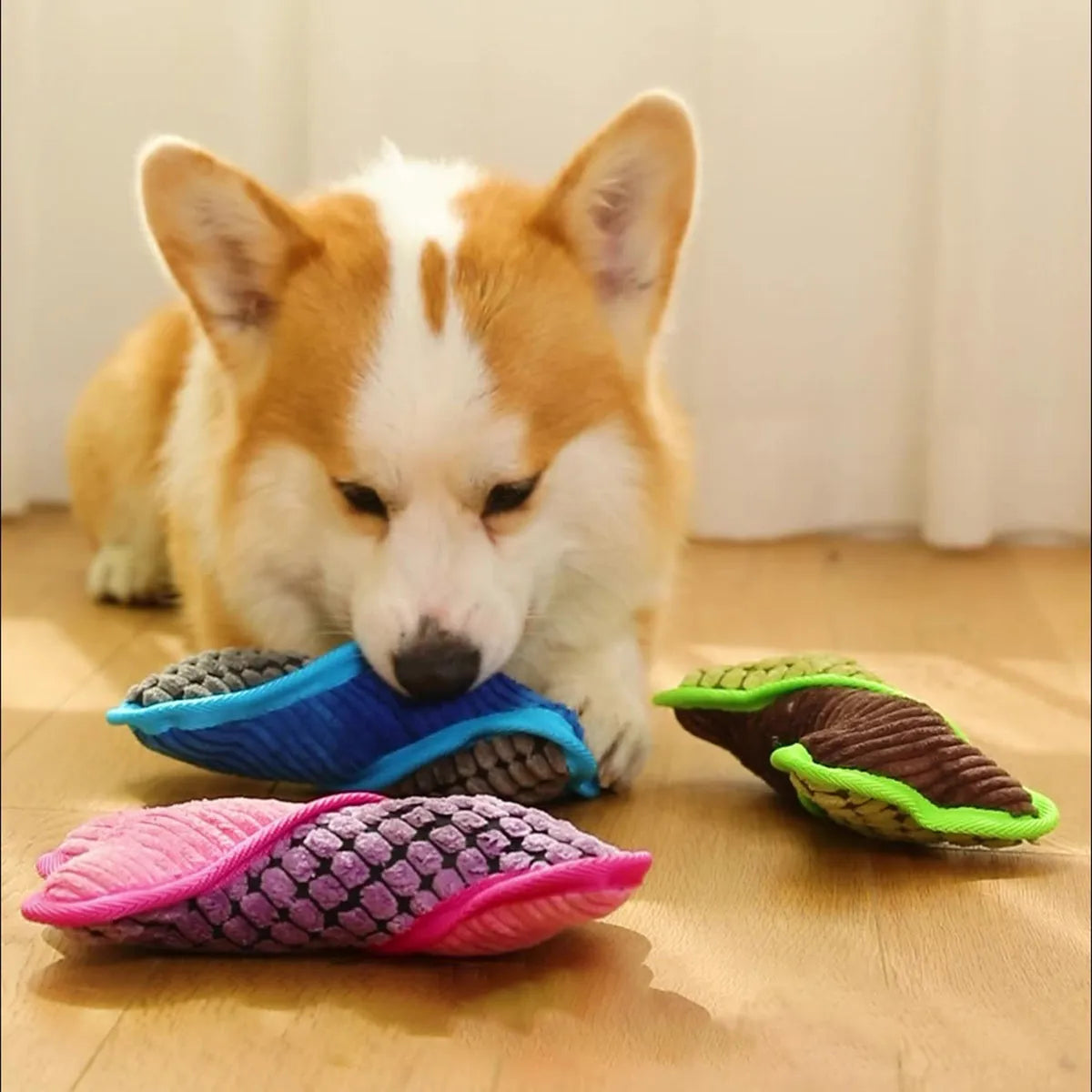 Blue dog toy with a squeaker bone, showing soft corn fleece lining and bite-resistant texture.