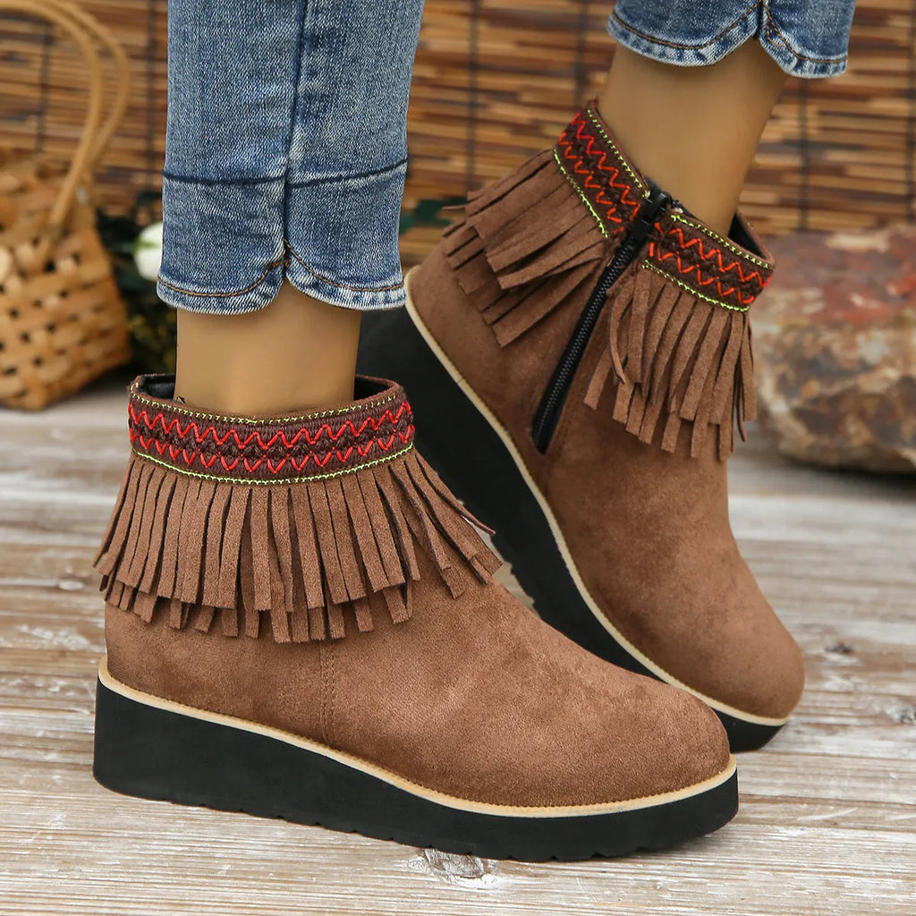Women's dark brown suede ankle boots with thick platform wedge sole, side zip, and tassel detail.