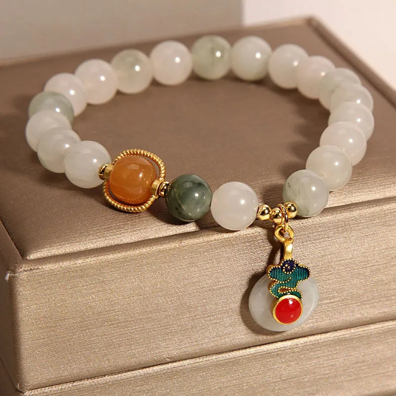 Women's ice jade bracelet with pearl accents and traditional Xiangyun peace buckle closure