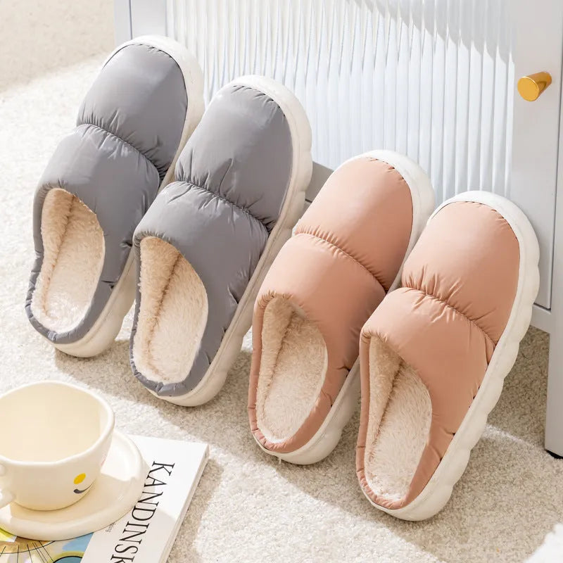 Blue down cotton slippers with artificial leather upper, thick rubber sole, and plush lining shown on a wooden floor.