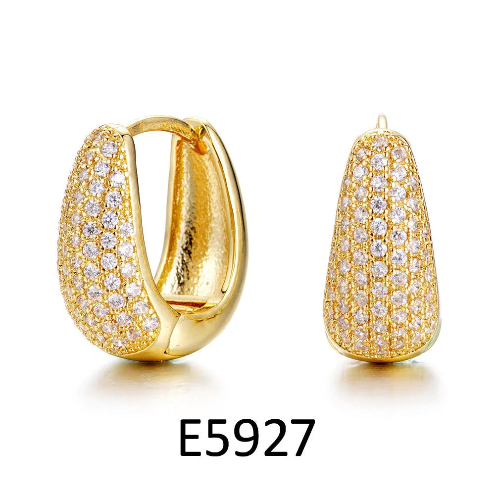Brass gold plated heart-shaped ear clip earrings with gang drill details on copper construction