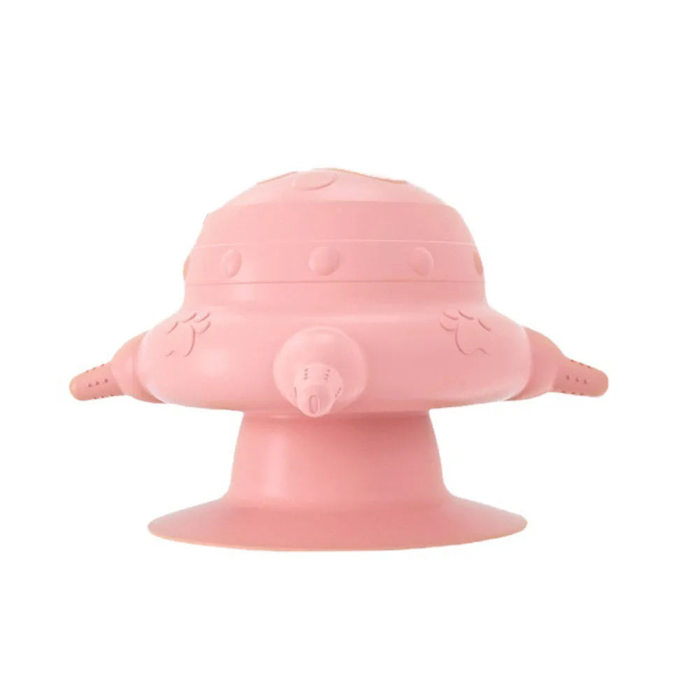 Pink silicone pet nursing device with milk bowl and four pacifiers for puppies and kittens on a flat base.