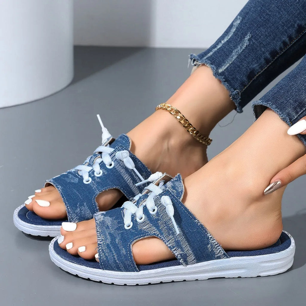 Blue Roman style flat canvas slippers for women with a rubber sole.