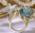Ocean blue topaz hummingbird open ring with real gold colour adjustable brass band