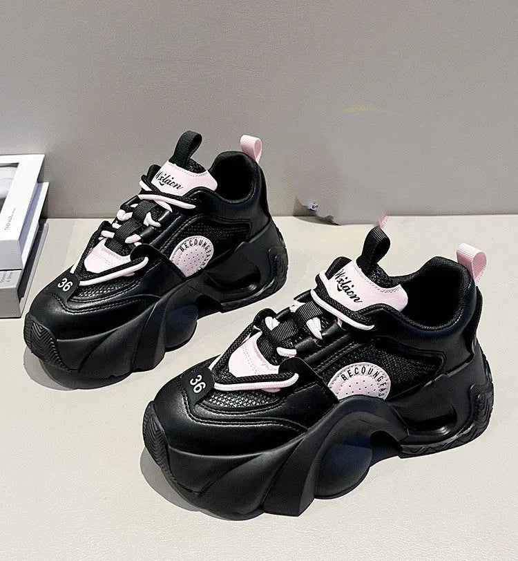 Women's pink casual sneakers with a cross strap, thick sole, and mesh lining on a white background.