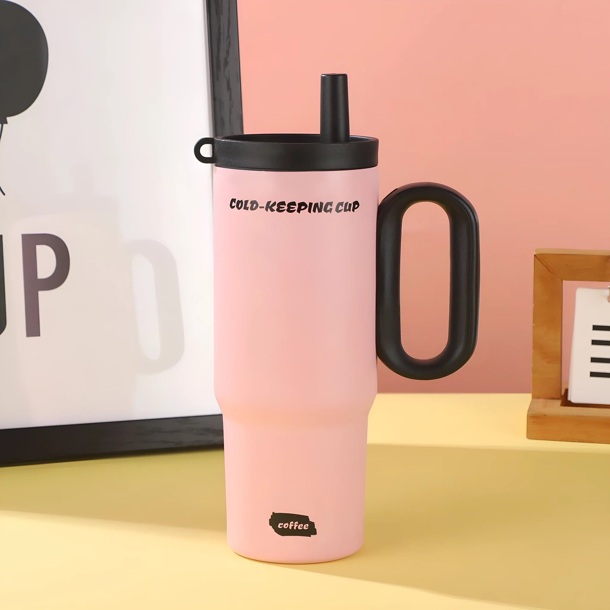 Portable plastic ice bucket with handle and large capacity, shown with a straw cup, for outdoor drink cooling.