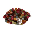 Close-up of a multi-layer beaded bracelet with 108 beads and a hanging lotus charm, made from alloy and tourmaline-coloured material.