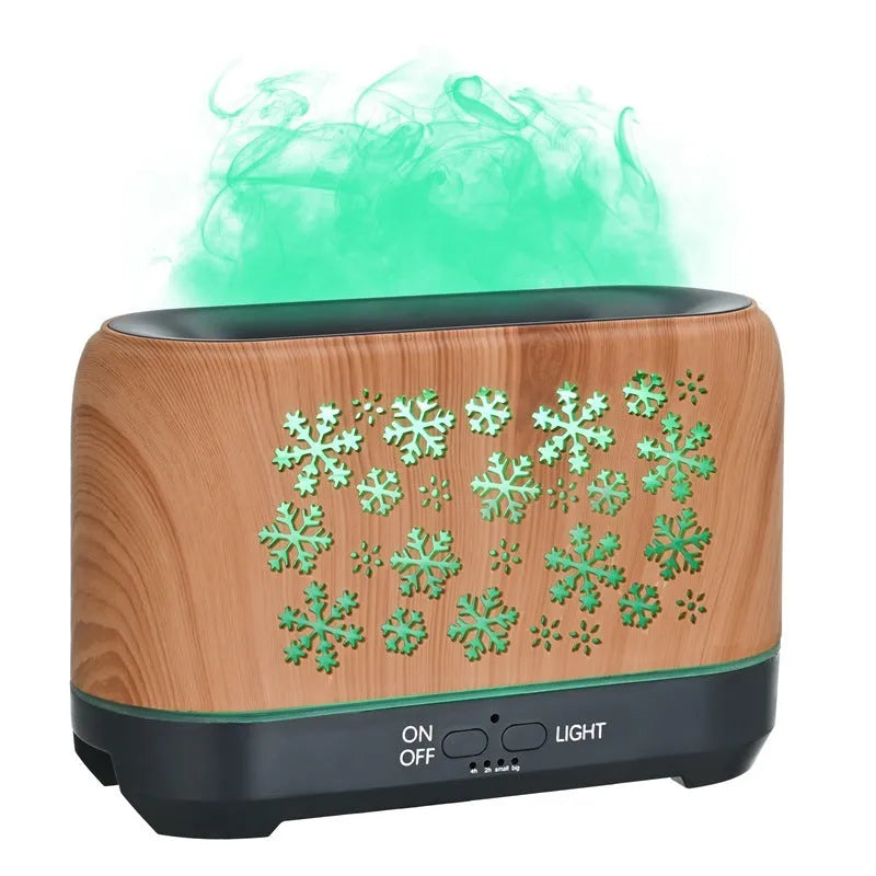 Square snowflake wood grain aromatherapy diffuser showing colourful flame effect mist and remote control on a desktop.