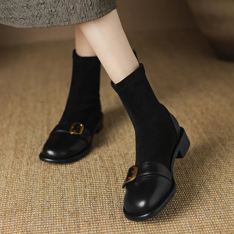 Black women's low heel Martin boots with front lace-up and buckle detail stitching.