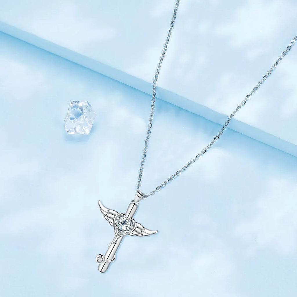 Close-up of a cross and angel wings charm on an adjustable stethoscope chain necklace.