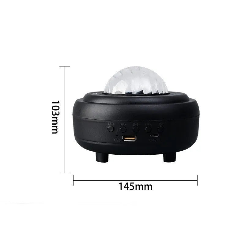 White galaxy star projector with Bluetooth speaker showing star projection on wall