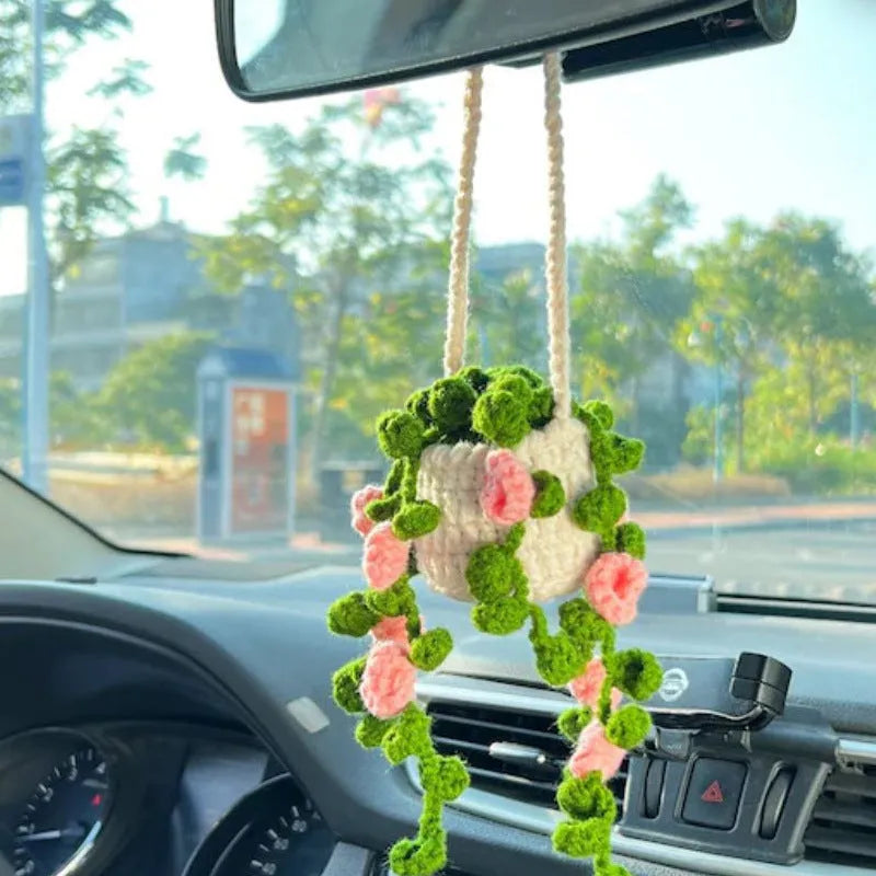 Green and white knitted wool car plant decoration with plastic base and hanging rope