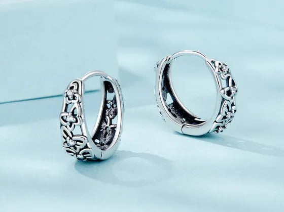 Retro hollow butterfly stud earrings in sterling silver with zircon accents, 14mm by 5mm.