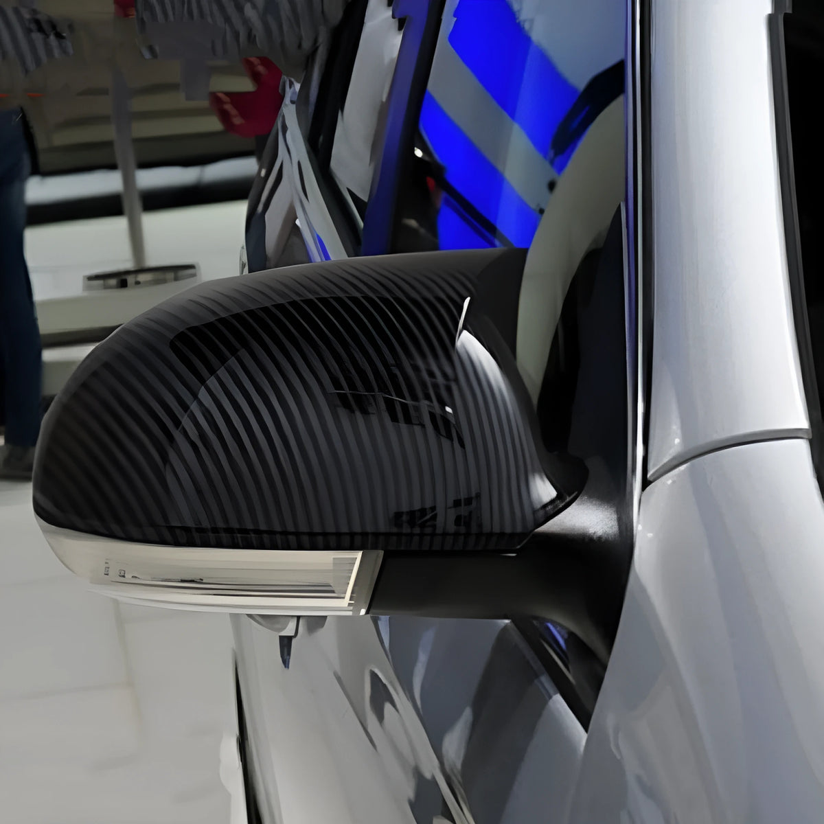 Pair of plastic mirror housings for Volkswagen Old Sagitar in black and carbon fibre finishes.