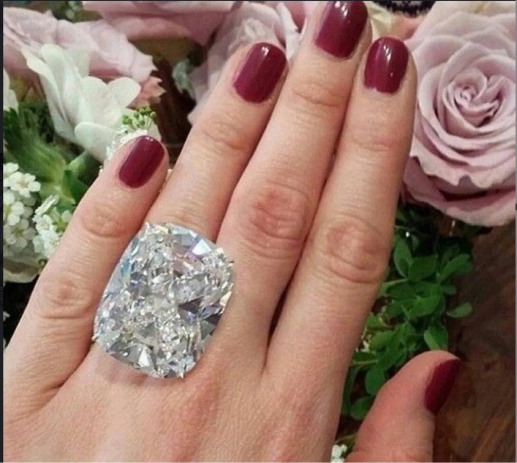 Simple inlaid white square diamond alloy ring for women in white gold colour on a grey background.