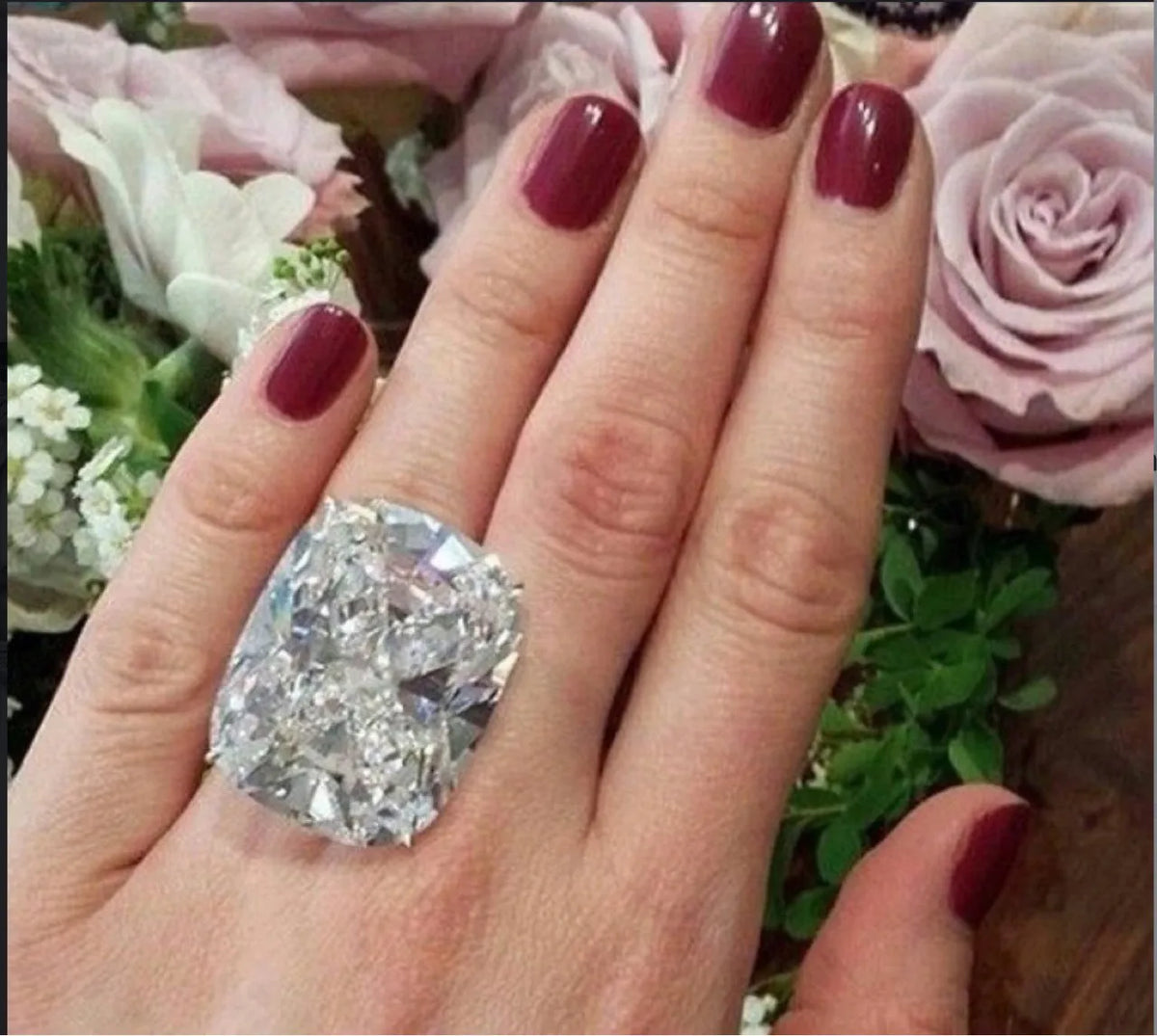 Simple inlaid white square diamond alloy ring for women in white gold colour on a grey background.