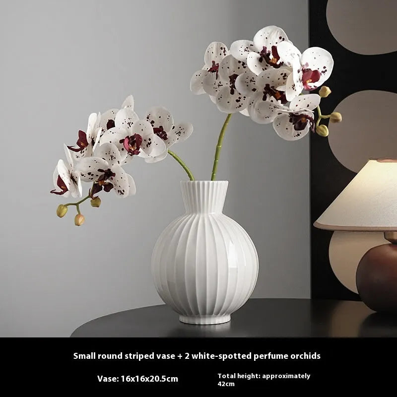 White ceramic ball striped vase in American country style on table with orchid arrangement
