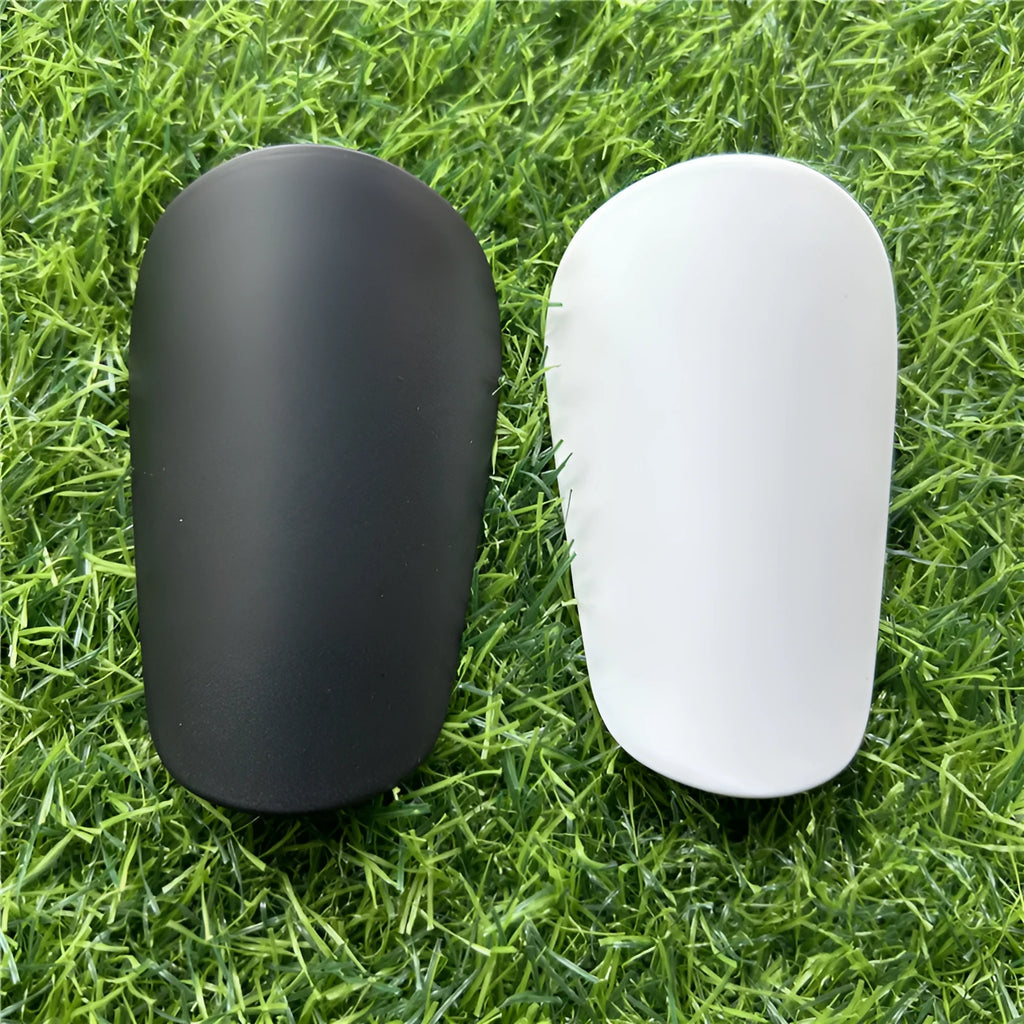 Extra small mini football shin guards in black and white colours showing 8x5cm plastic construction