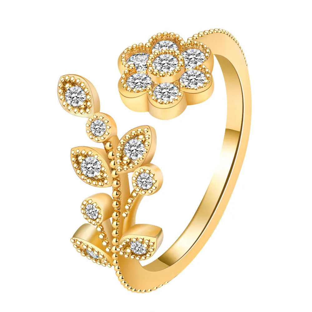 Women's open ring with diamond-treated flower and leaf design in gold colour on copper base