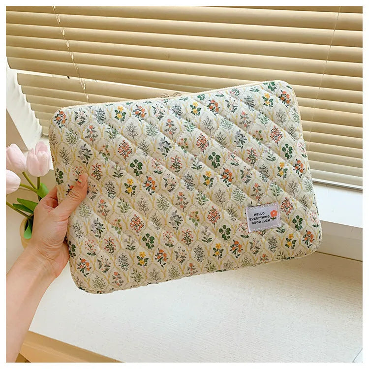 Printed cloth laptop bag for women shown in floral and heart patterns, available in small, medium, and large sizes.