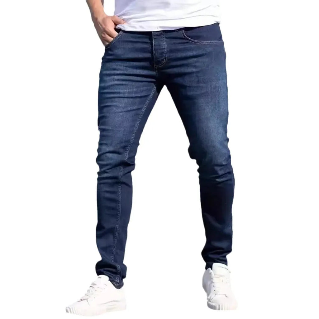 Men's dark blue cotton skinny jeans with elastic waistband shown on model