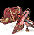 Women's pointed toe high heel shoes with stiletto heel and rhinestones, shown with a matching small bag.