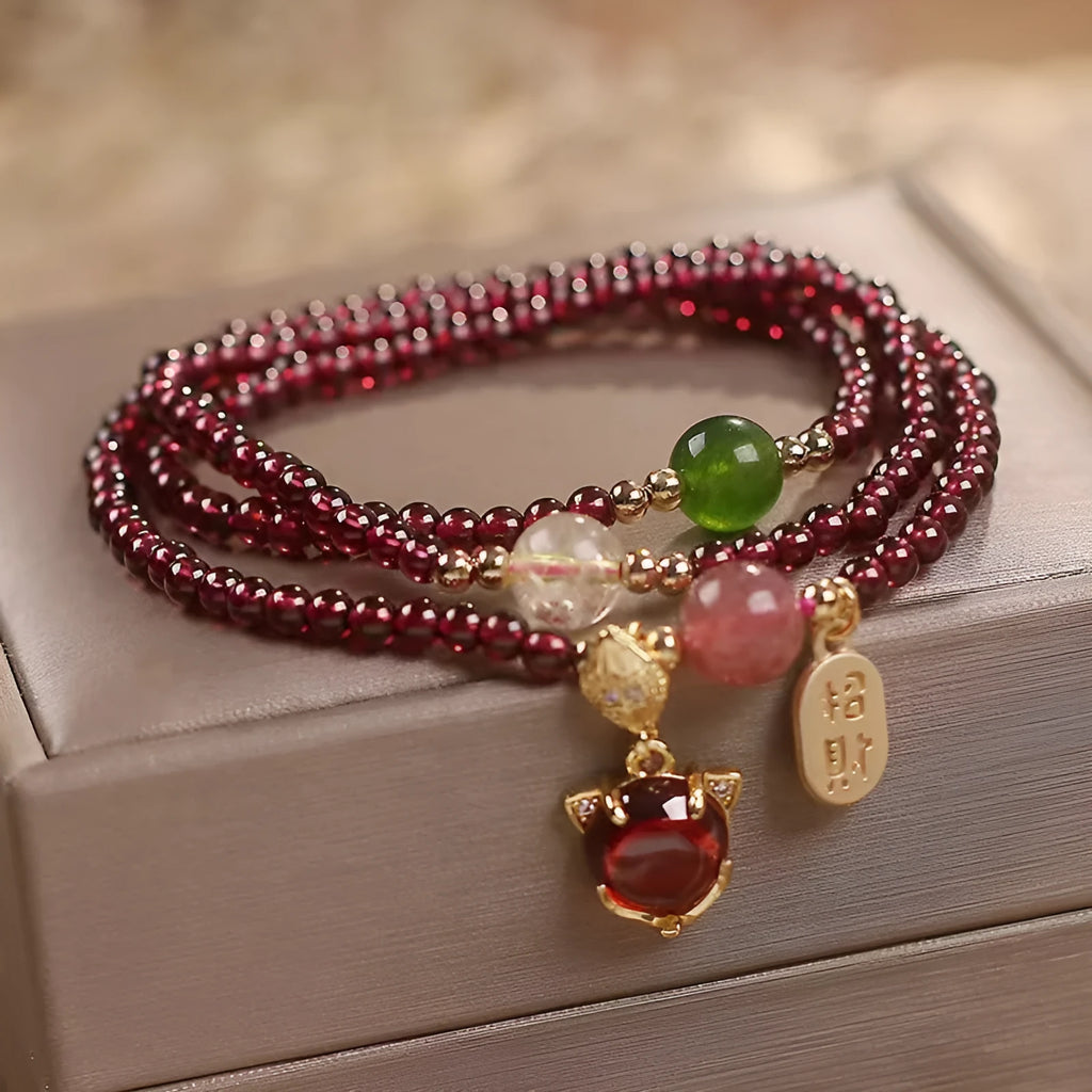 Purplish red garnet crystal fox bracelet on an adjustable rope for women.