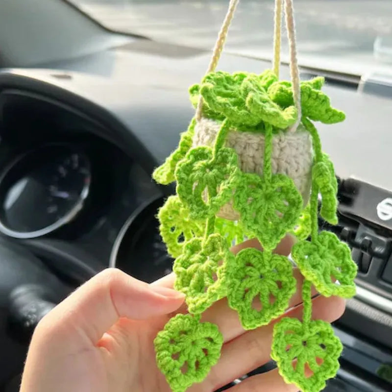 Green and white knitted wool car plant decoration with plastic base and hanging rope
