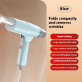 Blue and white handheld garment steamer with hanging iron attachment on wooden surface