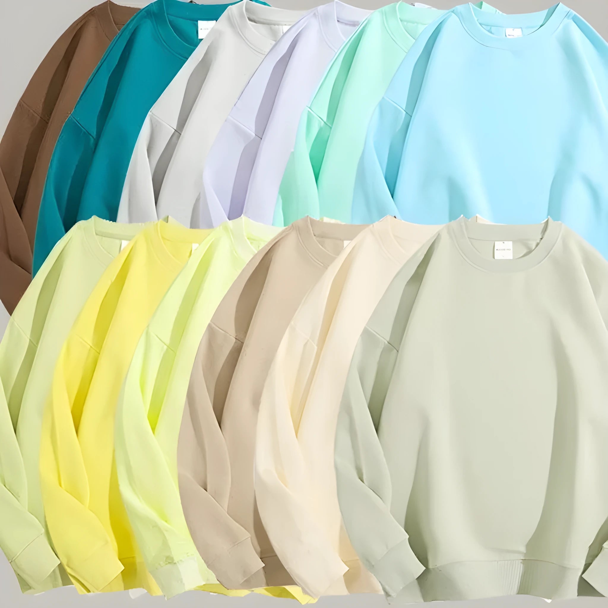 A loose-fitting, light blue off shoulder sweater with long sleeves and a round neck, made from cotton.