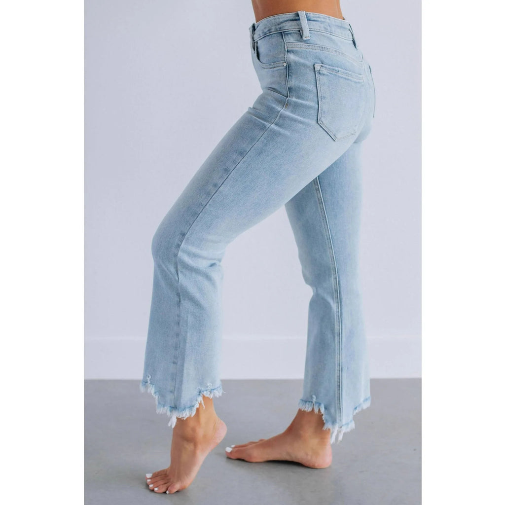 Women's solid colour denim jeans with hand-worn distressing in light blue wash, straight leg fit