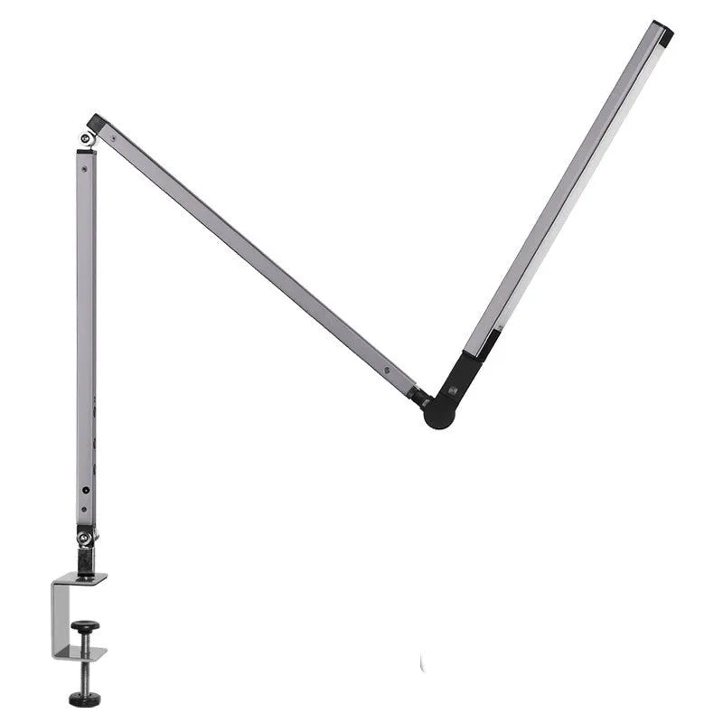 Black folding clip-on LED desk lamp with remote control on a wooden desk.
