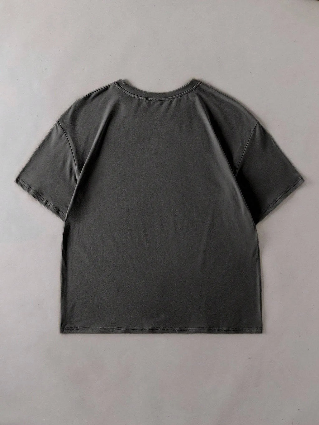 Loose fit cotton summer t-shirt in grey on a hanger, showing round neck and short sleeves.
