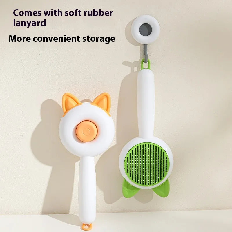 A greenish white and orange cat grooming comb with stainless steel teeth and a self-cleaning button.