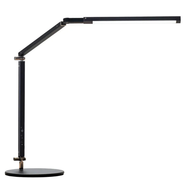Black folding clip-on LED desk lamp with remote control on a wooden desk.