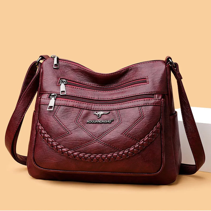 Soft PU leather crossbody shoulder bag in a horizontal square shape, shown in one of four colours: black, blue, red, or yellow.