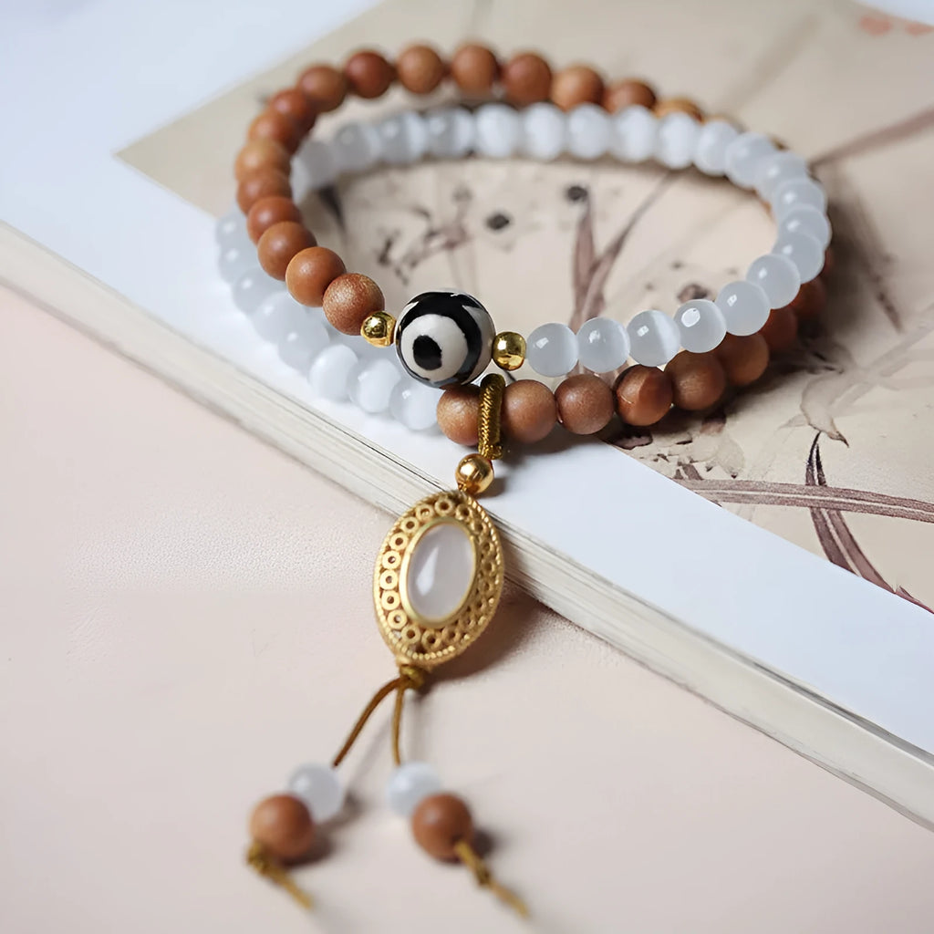 Sandalwood and opal double ring bracelet with polished finish and retro style.